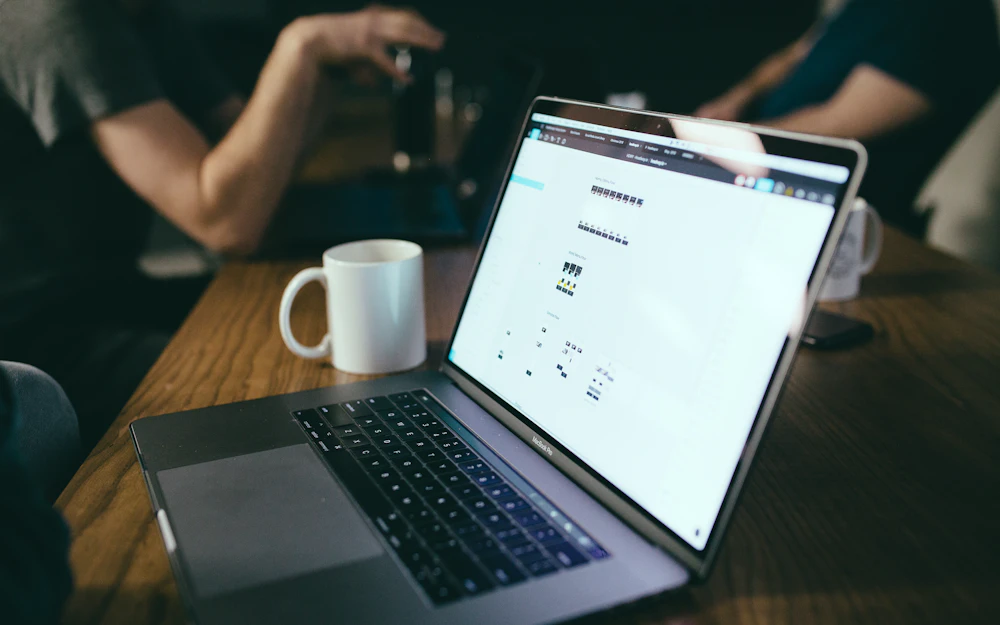 Laptop and coffee mug on a wooden table